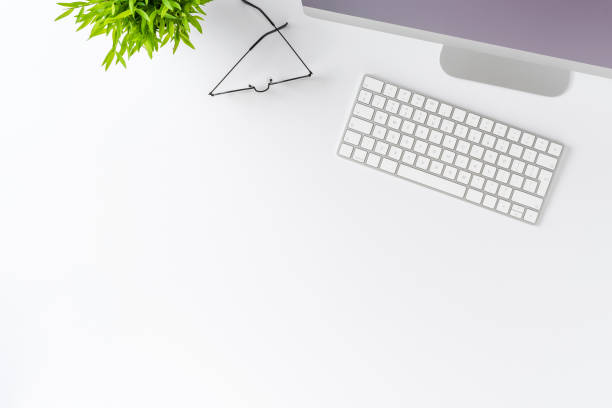 istock Overhead shot of computer with accessories on white table. Office desktop concept. Flat lay 1316003402