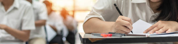 istock Exam at school with student's taking educational admission test in class, thinking hard, writing answer in university classroom, education and world literacy day concept 1316003409