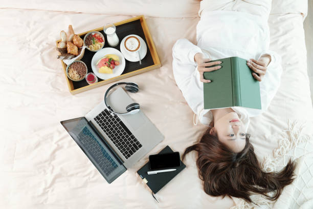 istock Woman reading thought provoking book 1316005597