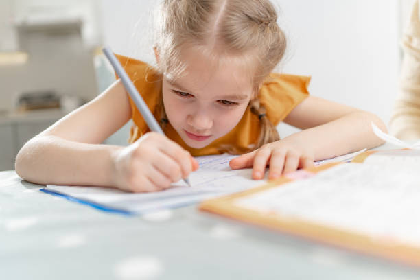 istock A diligent little schoolgirl does her homework. 1316005827