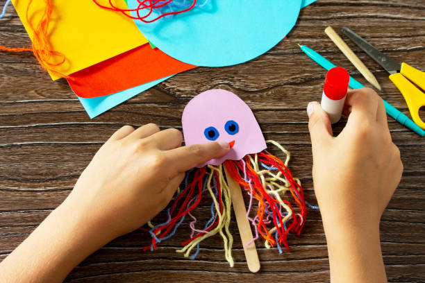 istock Instructions step 6. Summer puppet stics toy octopus. Handmade. Handmade. Childrens creativity project, crafts for kids. 1316006617