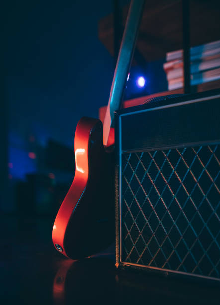 istock Electric guitar and classic amplifier under improvised home stage lightning 1316006638