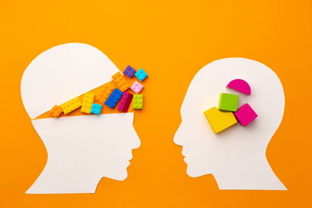 istock Papercut head silhouette with toy constructor pieces on yellow background 1316007172