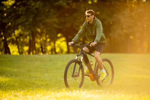 istock Young man riding ebike in the park 1316007382