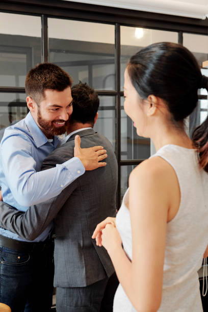 istock Happy hugging business people 1316007664