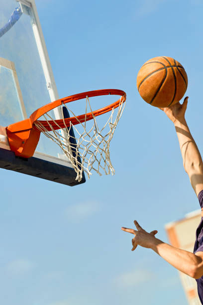istock guy throwing a basketball into the basket 1316007721