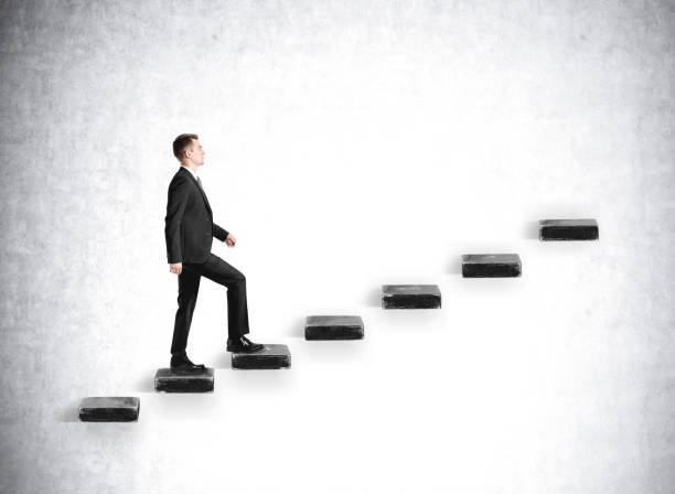 istock Businessman going up on stairs on grey concrete background, mockup 1316009008