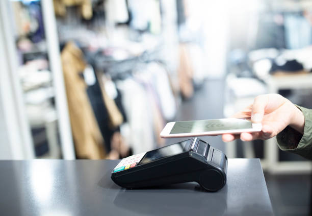 istock Tap and Pay via smart phone and contactless payment technology 1316009621