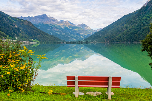 Lago di Poschiavo with Bernina range reflected in the water, Swiss canton of Graubunden