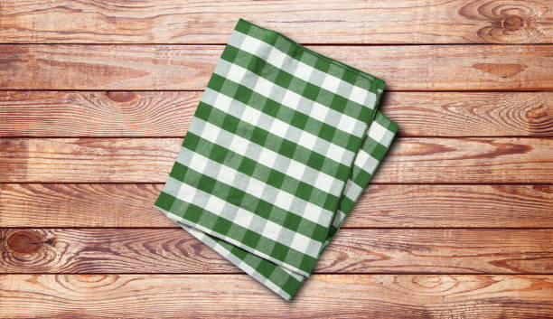 istock Napkin. Stack of colorful dish towels on brown desk 1316011615