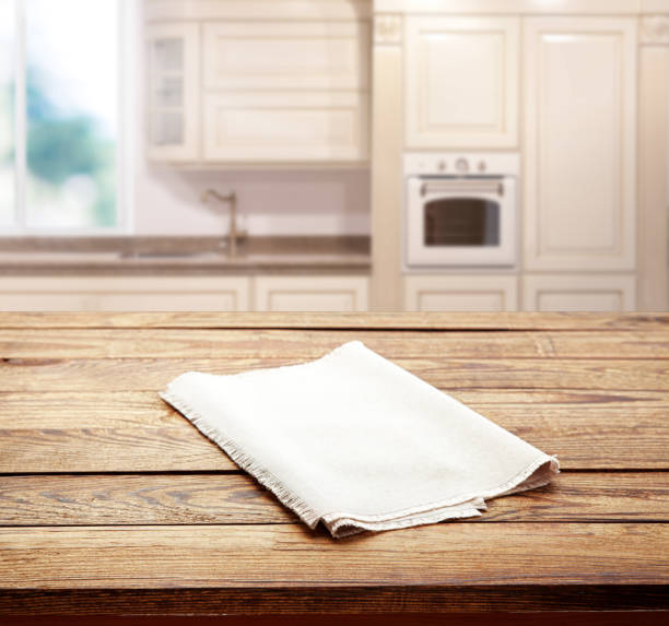 istock Empty white table cloth on wooden desk. Kitchen background. 1316011635
