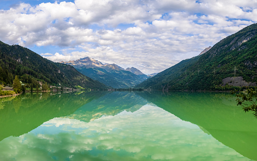 Lago di Poschiavo with Bernina range reflected in the water, Swiss canton of Graubunden (3 shots stitched)