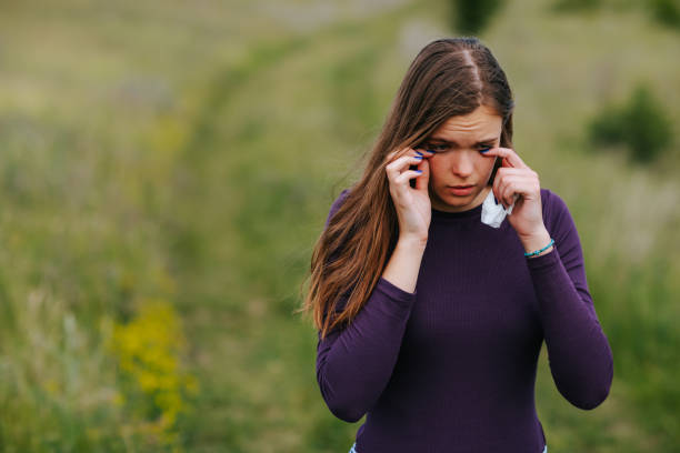 istock Allergic woman rubbing her eyes in nature 1316015413