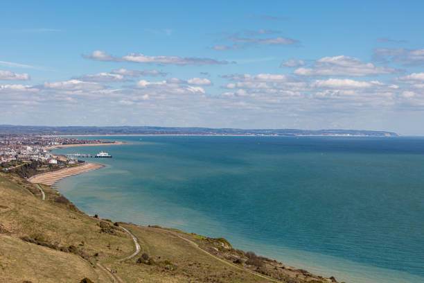 A View of the Ocean and Eastbourne from the Countryside near Beachy Head A view towards Eastbourne on the Sussex coast, on a sunny spring day eastbourne pier photos stock pictures, royalty-free photos & images