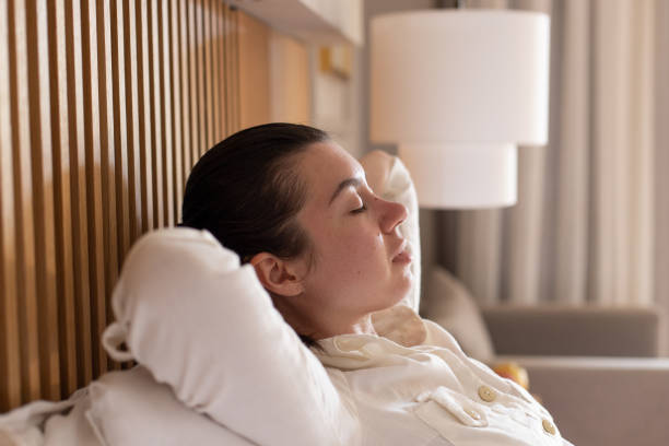 istock Relaxed young woman resting on comfortable sofa, her hands behind head 1316018874