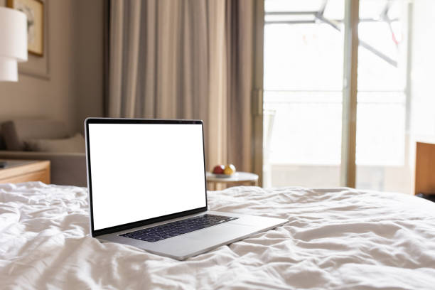 istock Laptop with blank white screen on the bed in modern home interior 1316018923