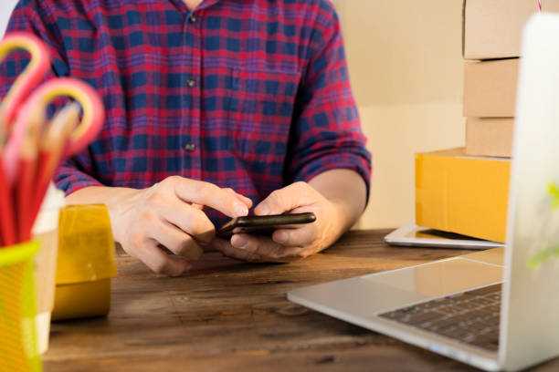 istock Businessman use smartphone thinking with pile of parcel on work desk 1316019031
