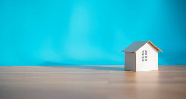 istock White paper house design isolated on blue background 1316020056
