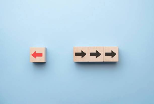 istock Red arrow print screen on wooden block change direction from right to left which differ from black arrows , Business and technology disruption concept. 1316020852