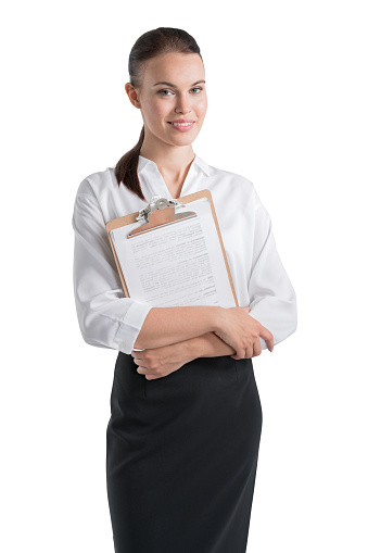 Office woman in white shirt and black skirt, holding business files smiling, looking at the camera. Concept of business worker, isolated over white background