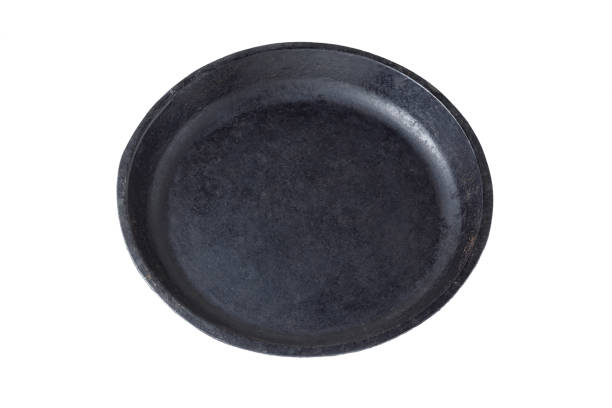 istock Old cast iron frying pan without handle on white background 1316022308