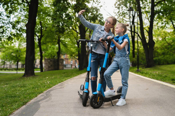 istock Happy mother and daughter taking selfie while  electric scooters ride 1316022825