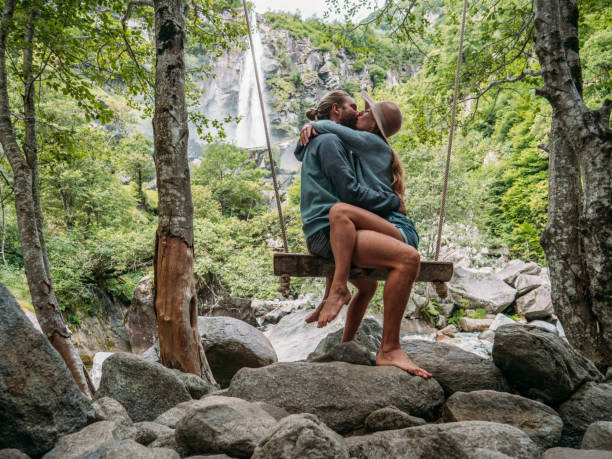 Couple embracing on wooden swing near waterfall They cuddle on wooden swing in nature.
Ticino, Switzerland kissing on the mouth stock pictures, royalty-free photos & images