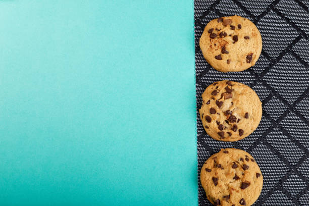istock three cookies with chocolate on a black wicker napkin and blue background 1316024652