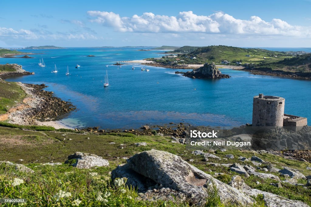 Tresco, Isles of Scilly, Cornwall, UK Tresco Channel showing Cromwell's Castle and Isle of Bryher Isles of Scilly Stock Photo