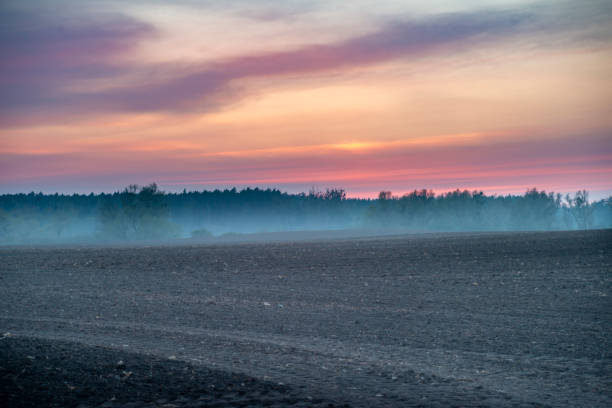 Sunset over the bare soil field in the North Brandenburg, Germany