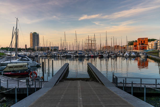 Travemuende, Schleswig-Holstein, Germany - June 17, 2020: The marina in Priwall with old lighthouse and the the Maritime hotel in the background