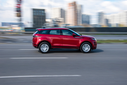 Ukraine, Kyiv - 26 April 2021: Red Land Rover Range Rover Evoque car moving on the street. Editorial