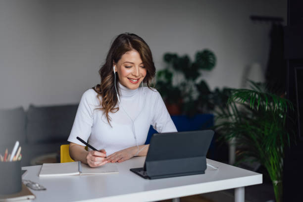 istock Smiling beautiful businesswoman writing in diary 1316030976