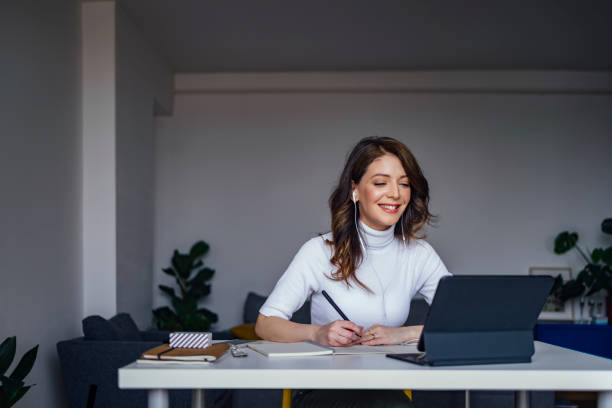 istock Smiling female professional writing in diary 1316031029