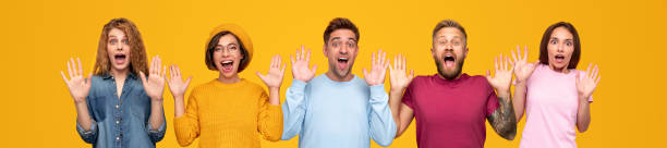 istock Happy people with hands raised in great surprise 1316031657