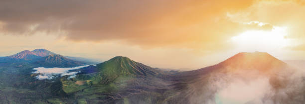 istock View from above, stunning panoramic view of the Ijen volcano complex during a beautiful sunrise with the turquoise acidic crater lake in the foreground. East Java, Indonesia. 1316032324