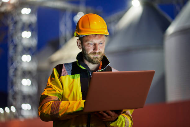 istock Worker with safety helmet and laptop working in factory during night shift 1316032441