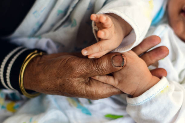 istock old man holding child's hands. selective focus 1316033004