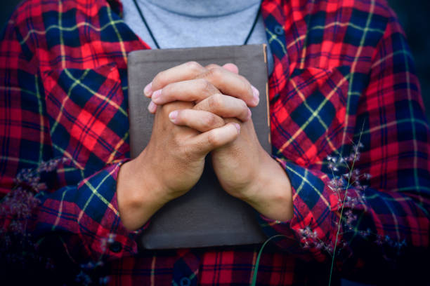 istock A Man praying holding a Holy Bible. christian concept. 1316033077