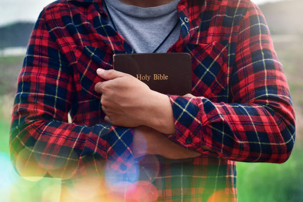 istock Young man holding a Bible closely. christian concept. 1316033207