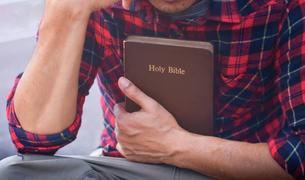 istock a man holding a bible and pray, believe concept 1316033211