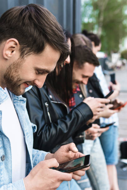 istock Friends using smartphones for messaging instead of real communication 1316034080