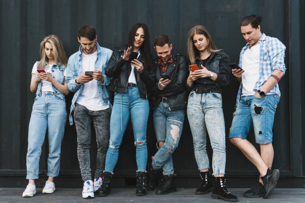 istock Friends using smartphones for messaging instead of real communication 1316034307
