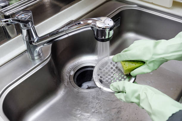istock Women cleaning the kitchen sink 1316035709