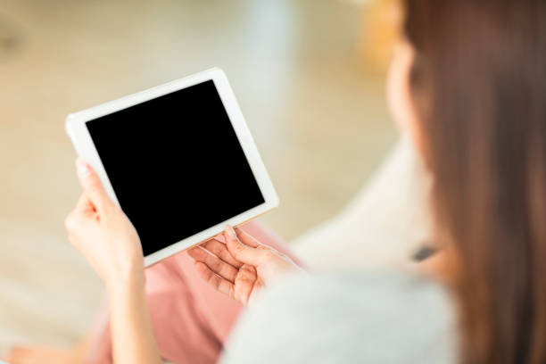 istock Woman Hand holding tablet with blank screen 1316036952
