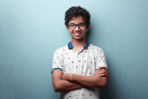portrait of a smiling young boy of indian origin - schoolboy relaxation happiness confidence imagens e fotografias de stock