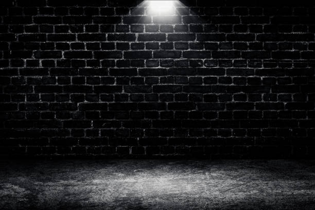 istock Studio dark room black brick wall and spotlight with concrete floor grunge texture background. 1316038075