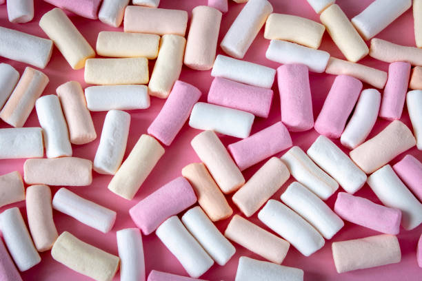 istock Colorful marshmallows on a pink background. Close-up. Selective focus. 1316040330