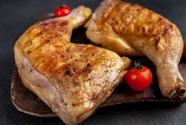 istock two grilled chicken legs with spices on a cutting board on a stone background 1316041933