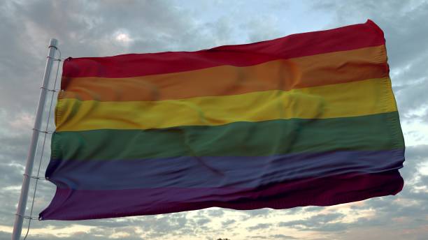 istock LGBT pride flag waving in the wind against deep beautiful sky at sunset. 3d rendering 1316042234